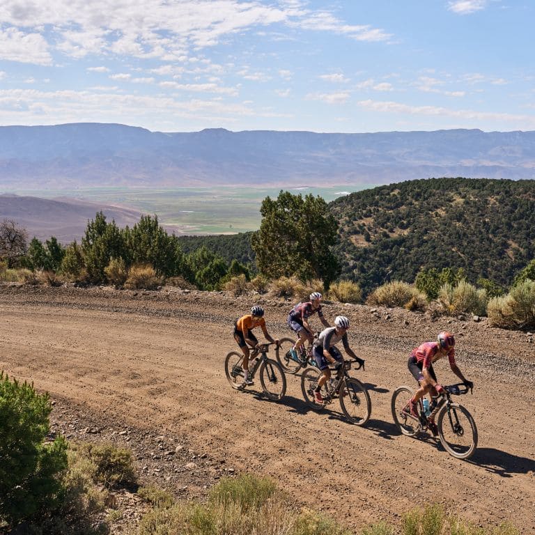 gravel cyclists in desert landscape