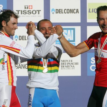 Italy's Olympic champion Paolo Bettini, left, looks at his