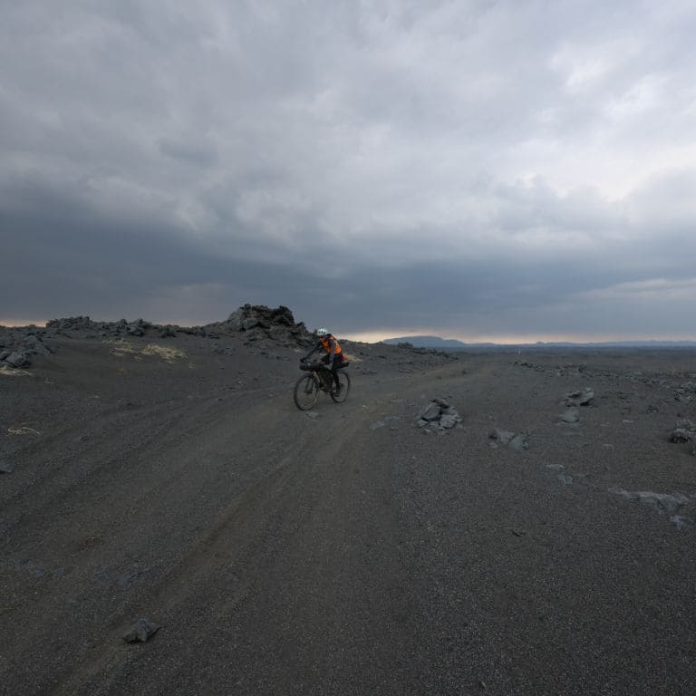 bikepacking in iceland with black earth and moon landscape