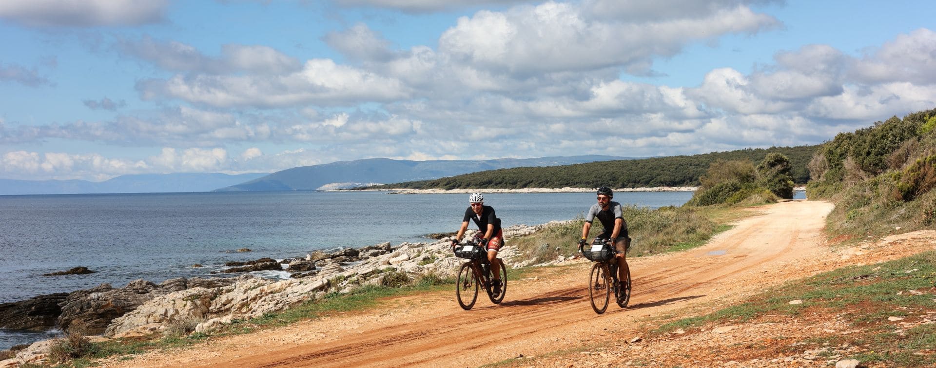 two gravel cyclists along the Istrian sea two gravel cyclists along the Istrian sea
