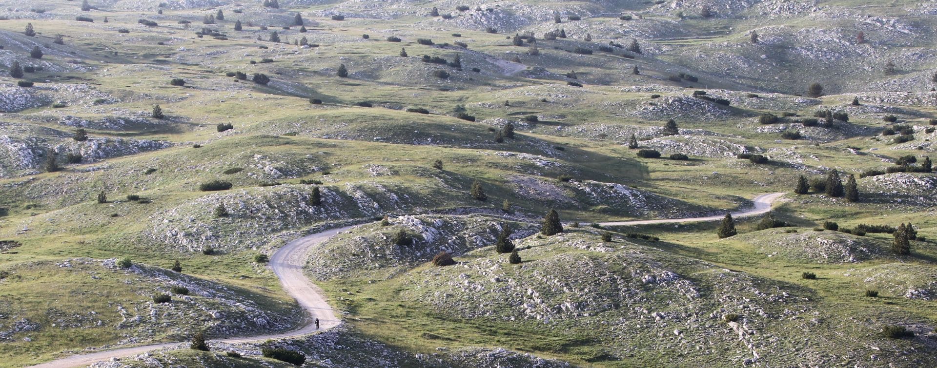 cyclist in the middle of balkan landscape