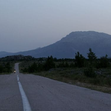 ultra trail cyclist doing trans balkan race at night