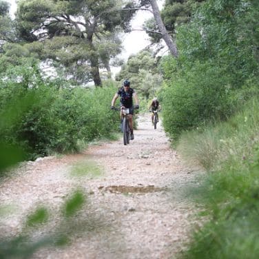 bikepacking cyclists pedal in the off road roads of the Carso Trail