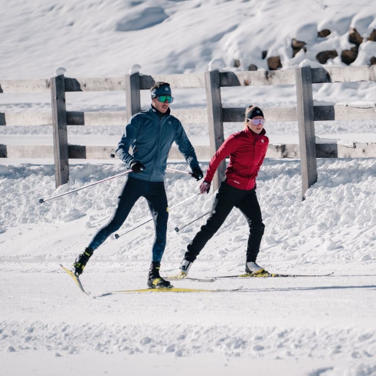a man and a woman cross-country skiing