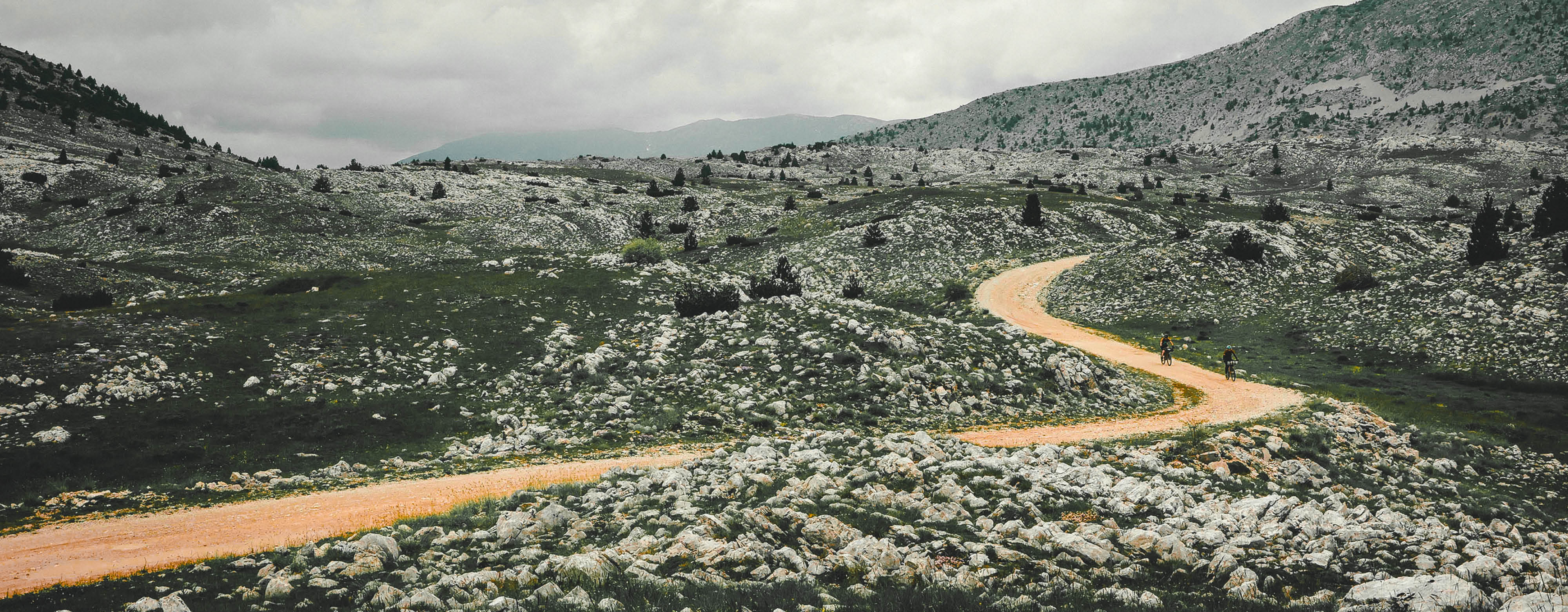 gravel cyclist with mountain landscape