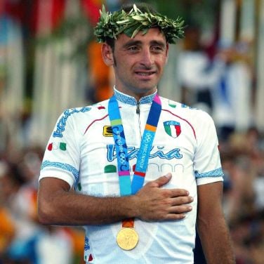 Italy's Olympic champion Paolo Bettini, left, looks at his