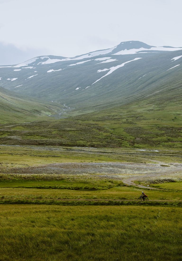 cyclist bikepacking in wild landscape