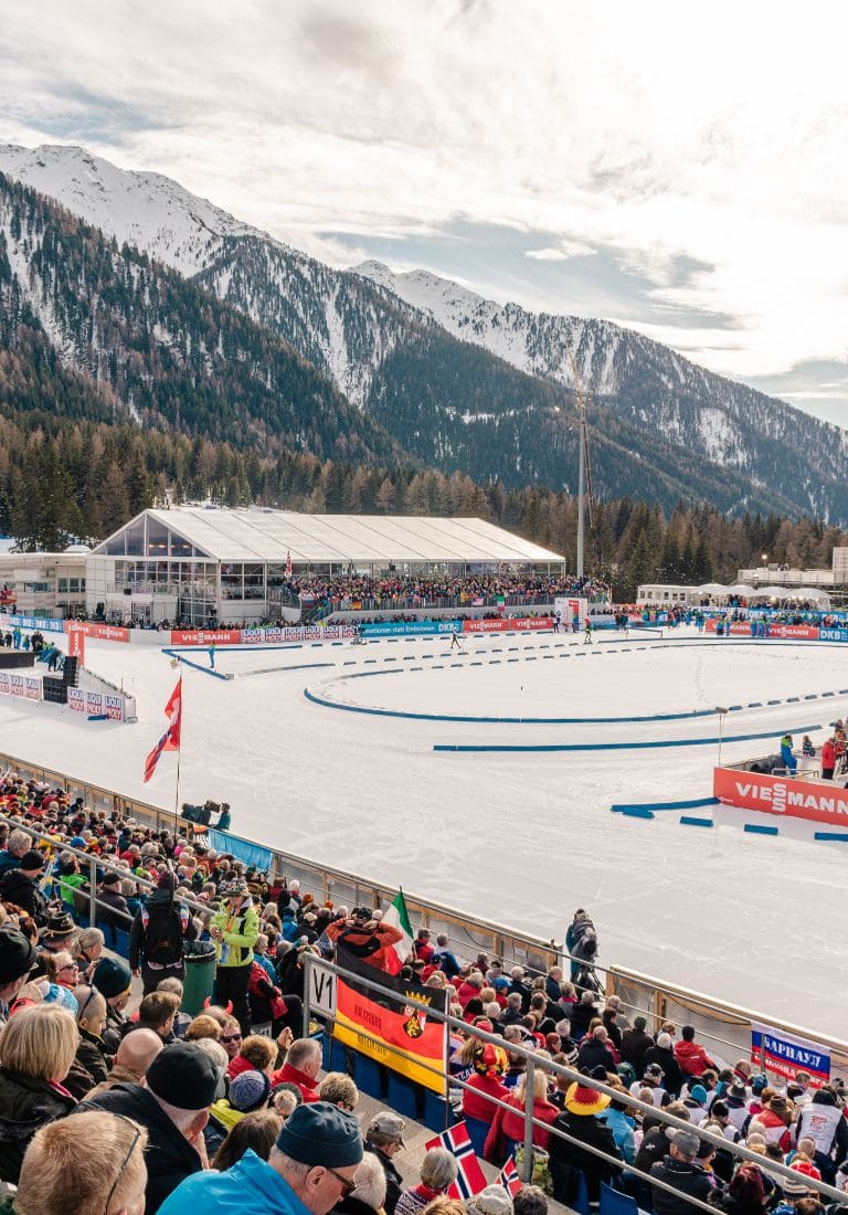 warm public in the stands of the Anterselva biathlon stadium in a snowy landscape warm public in the stands of the Anterselva biathlon stadium in a snowy landscape